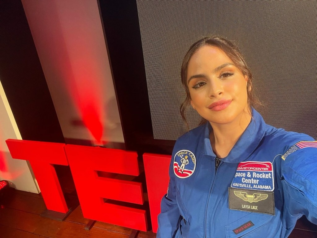 Laysa Peixoto poses for a photo wearing a NASA Space Camp jumpsuit.