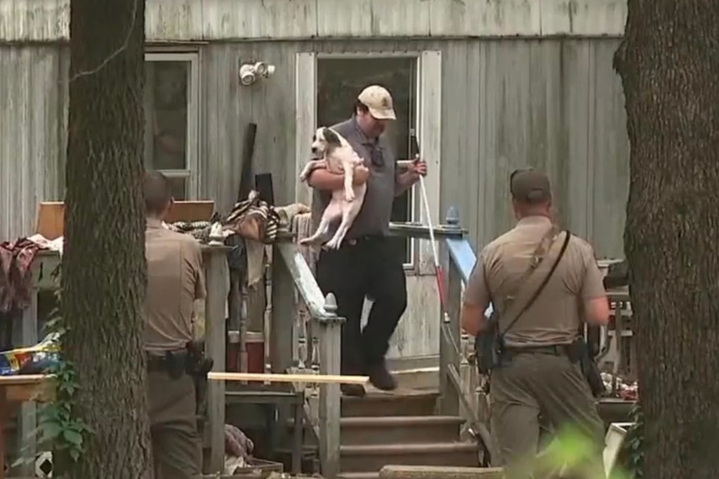A neighbor said the first responding officer arrived at the scene and discharged his sidearm multiple times to get the dogs away