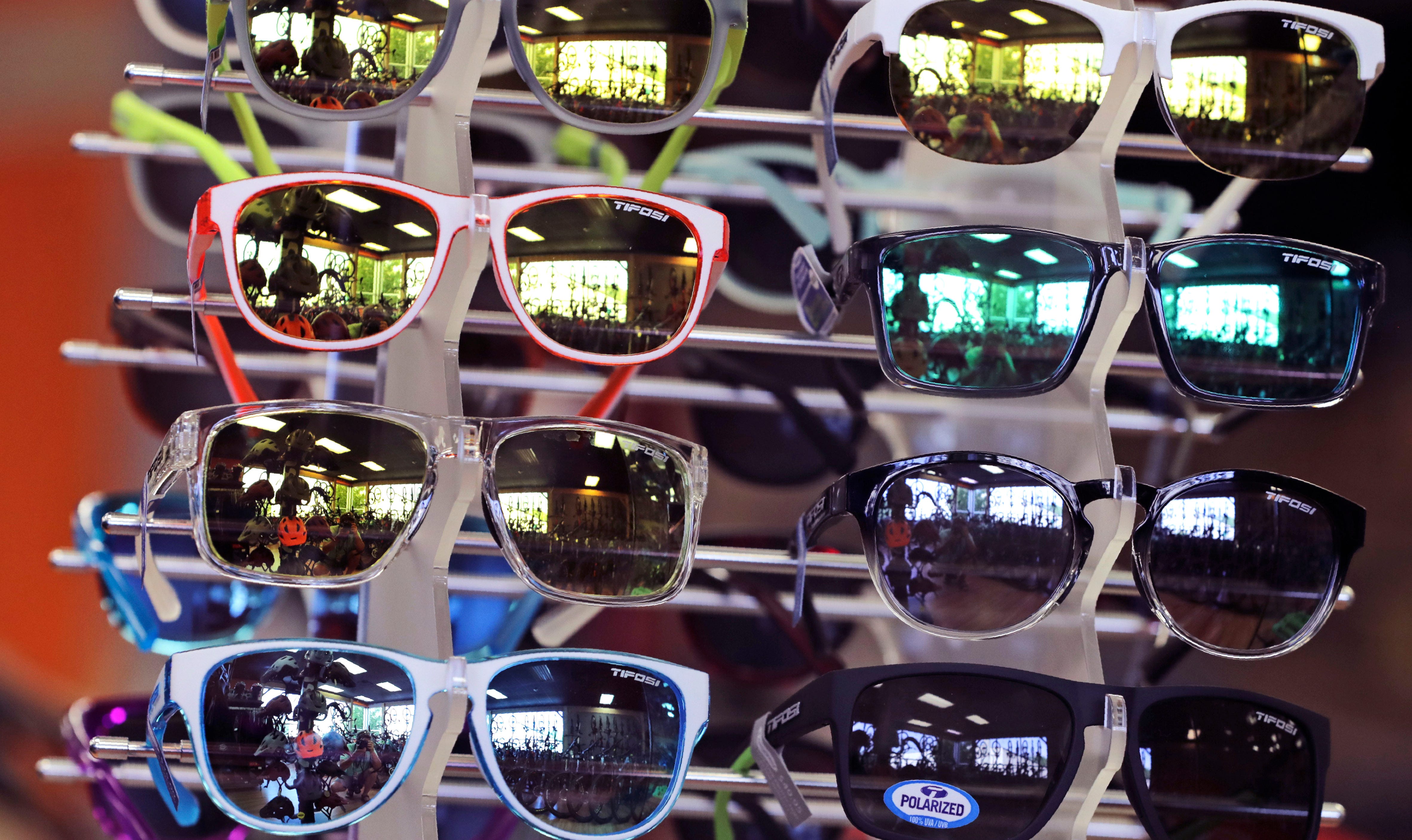 Sunglasses displayed on a rack for sale.