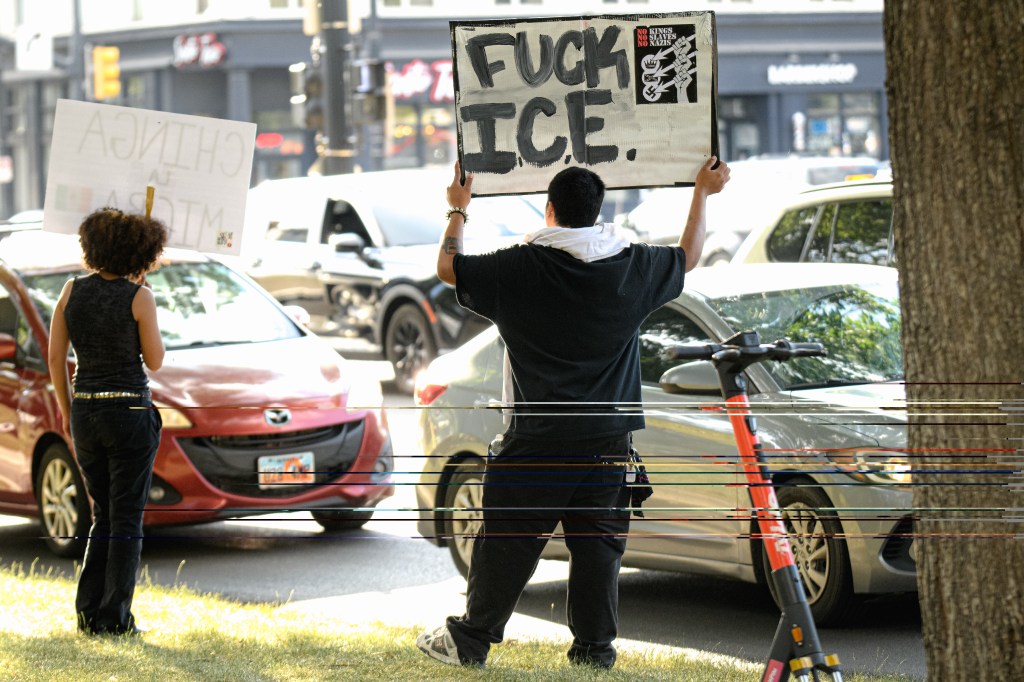 Protestors holding signs at a Salt Lake City ICE protest.