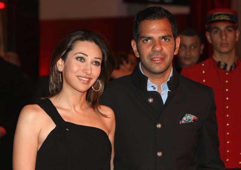 DUBAI, UNITED ARAB EMIRATES - MARCH 26: Sanjay Kapur (R) and Karishma Kapur attend the inauguration of the new Cartier Boutique at Dubai Mall on March 26, 2009 in Dubai, United Arab Emirates. Today Cartier officially inaugurated its largest boutique in the Middle East in the prominent and lavish Dubai Mall. The boutique occupies a space of more than 700 m2 and is ranked among the top 5 largest flag-ship boutiques in the world. (Photo by Chris Jackson/Getty Images for Cartier)