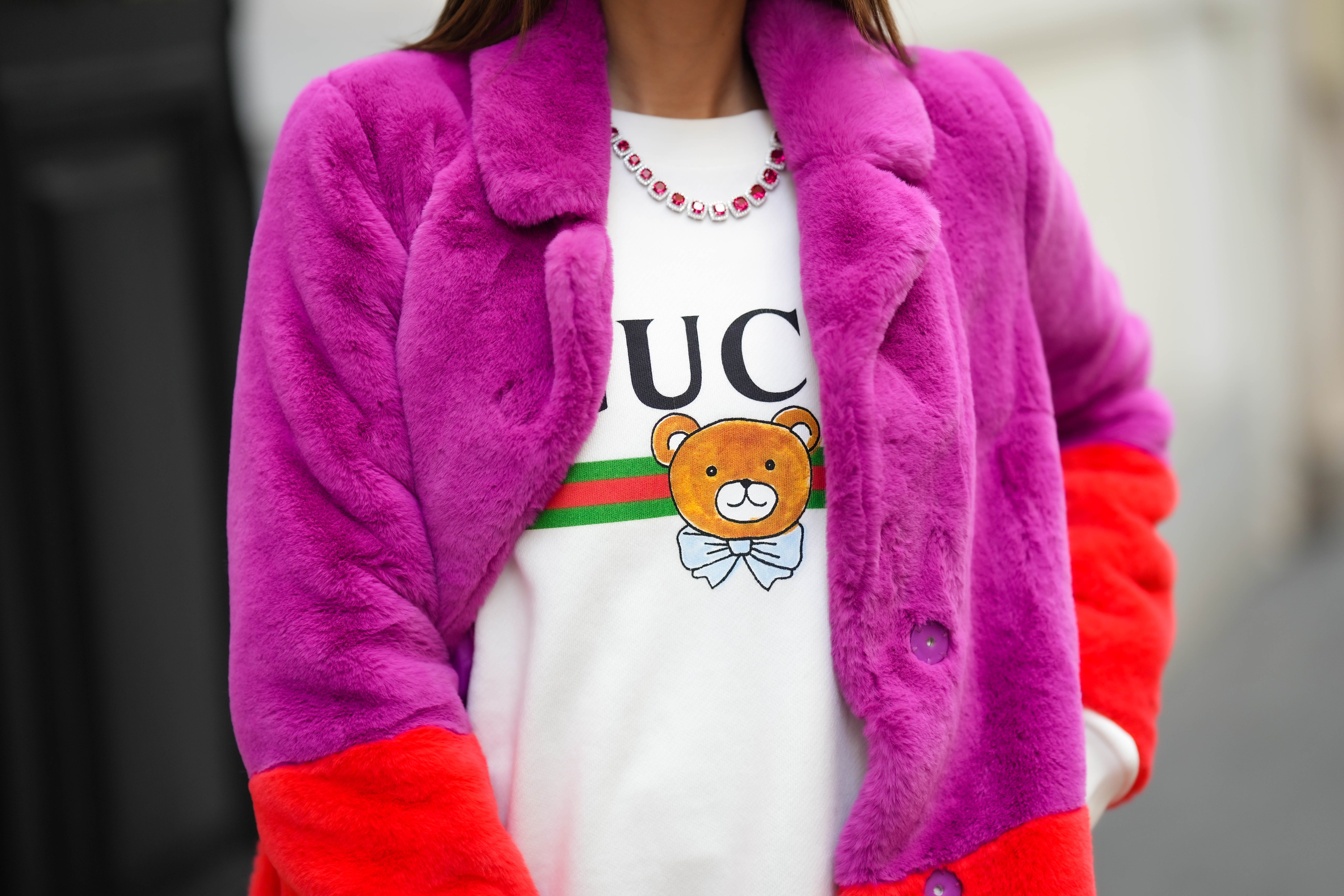 Furry magenta jacket paired with Gucci shirt and pink-stone diamond necklace