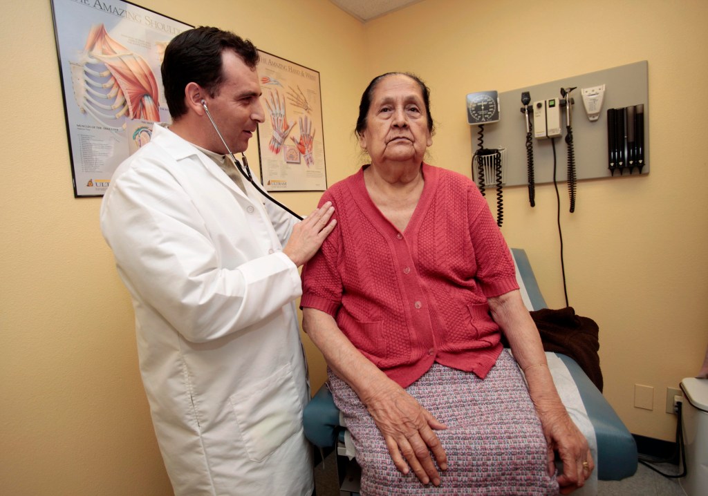 Doctor examining elderly patient.