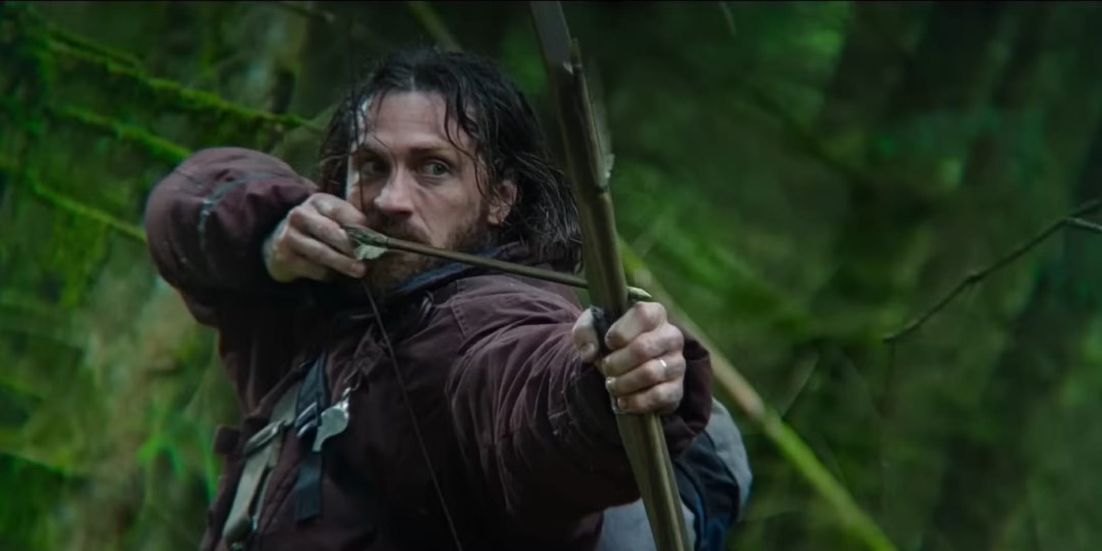 Aaron Taylor-Johnson shooting a bow and arrow