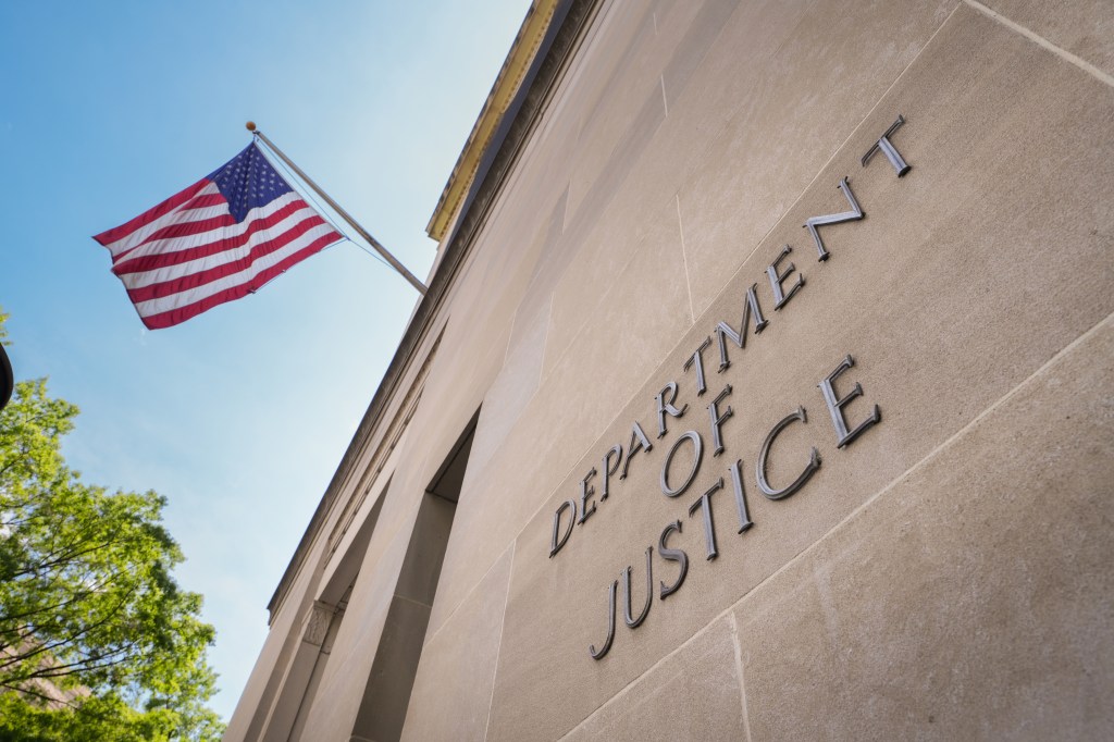 Department of Justice building with American flag.
