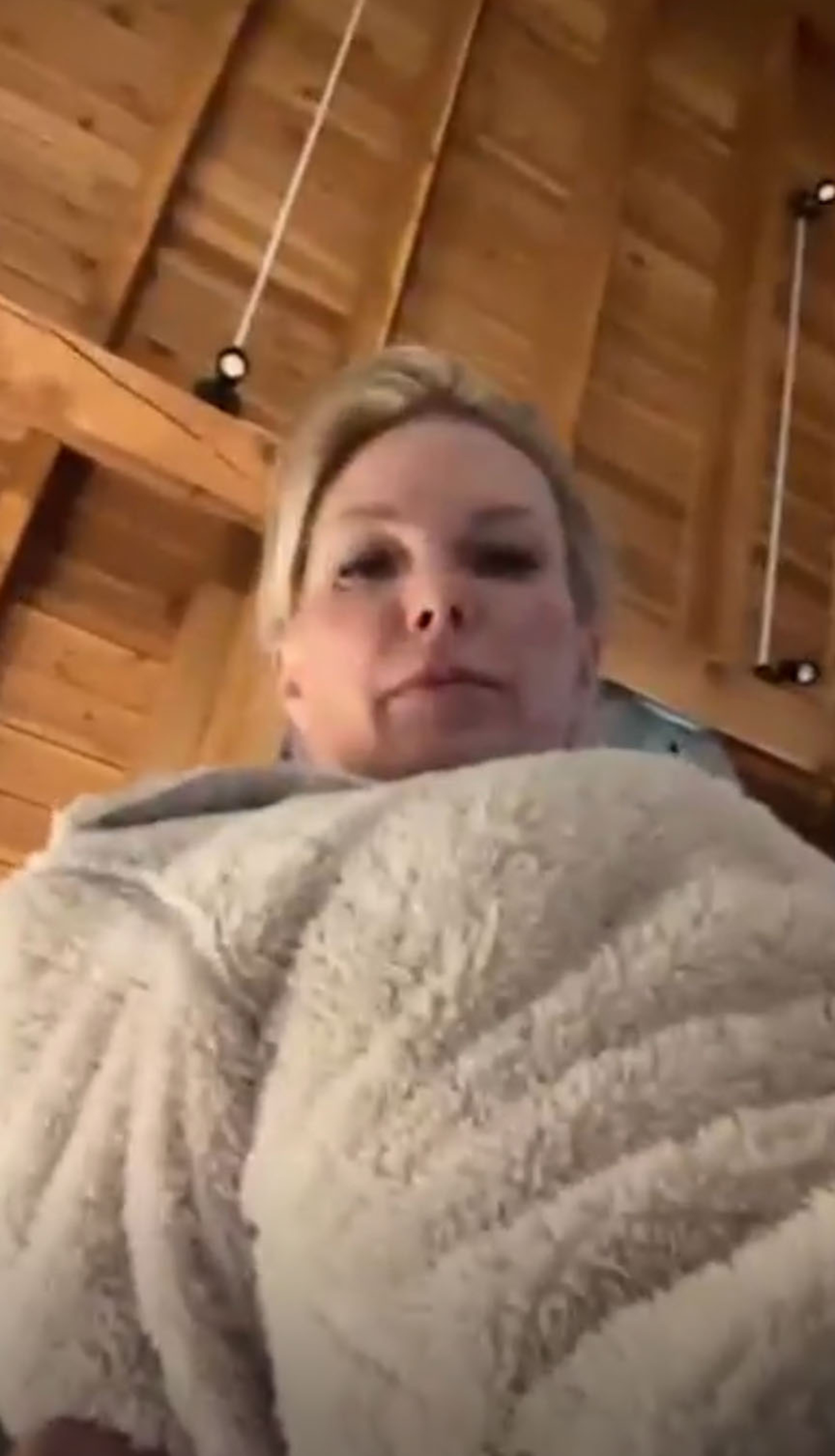 Kelley Wolf looks down at a camera. 