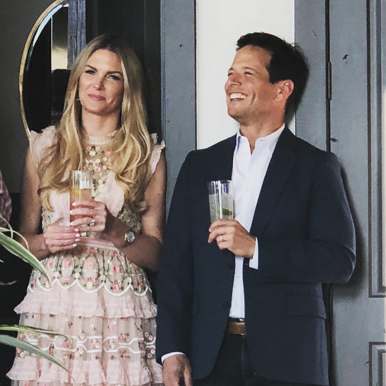 Scott and Kelley Wolf smile at an event. 