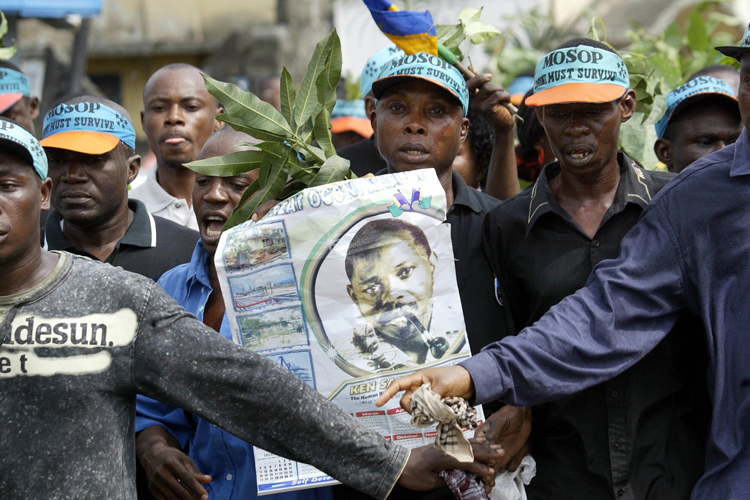Ogoni people carry a poster in remembrance of environmentalist activist Ken Saro-Wiwa during a march.