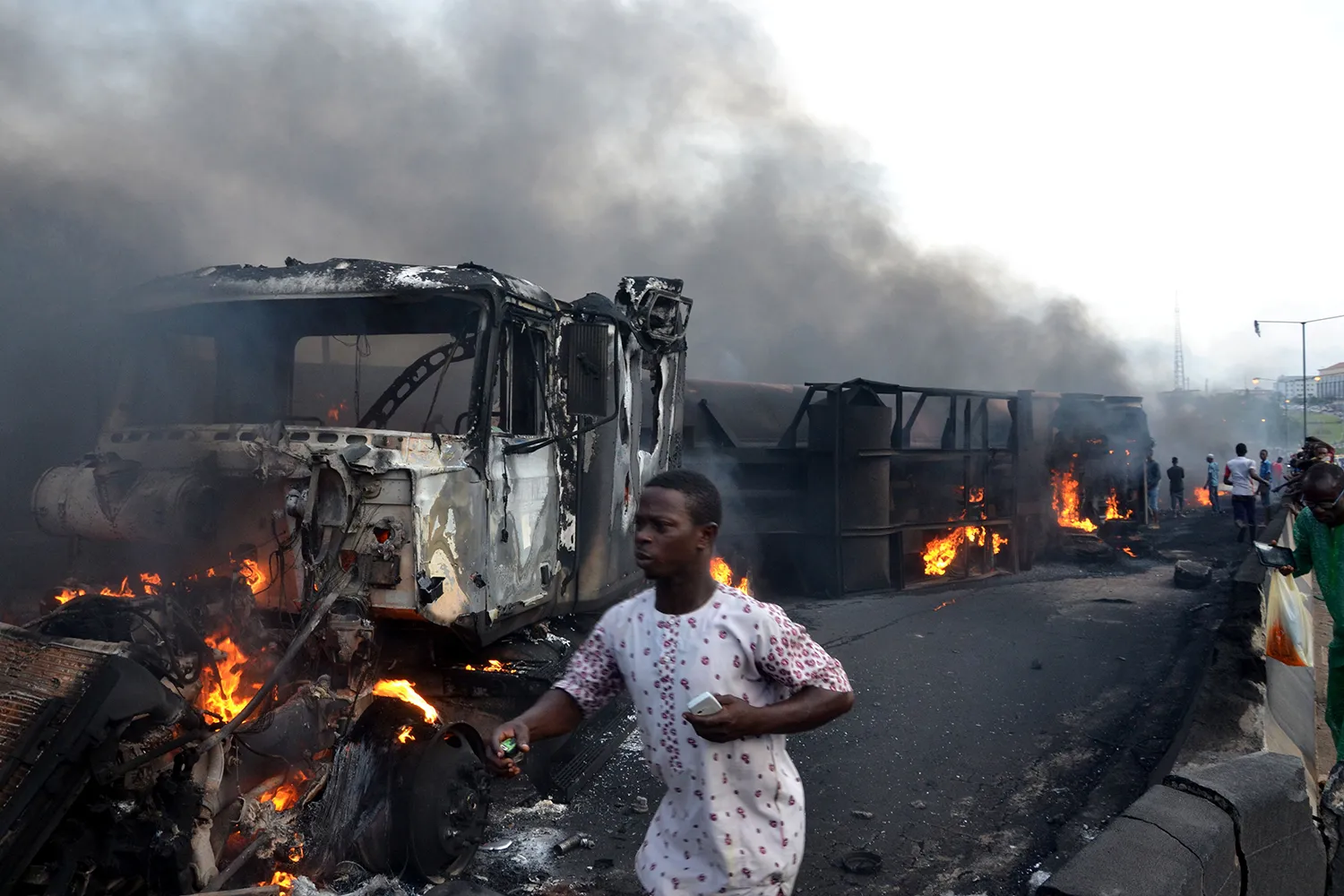 Burning cars are seen on a highway after an oil tanker exploded.
