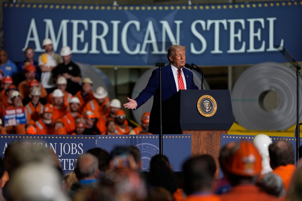 Trump speaking at a podium before a crowd of people.
