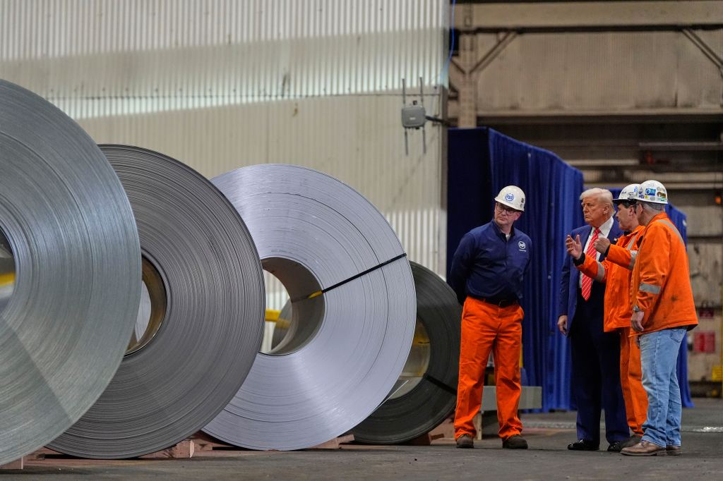 Trump with workers in a steel mill.