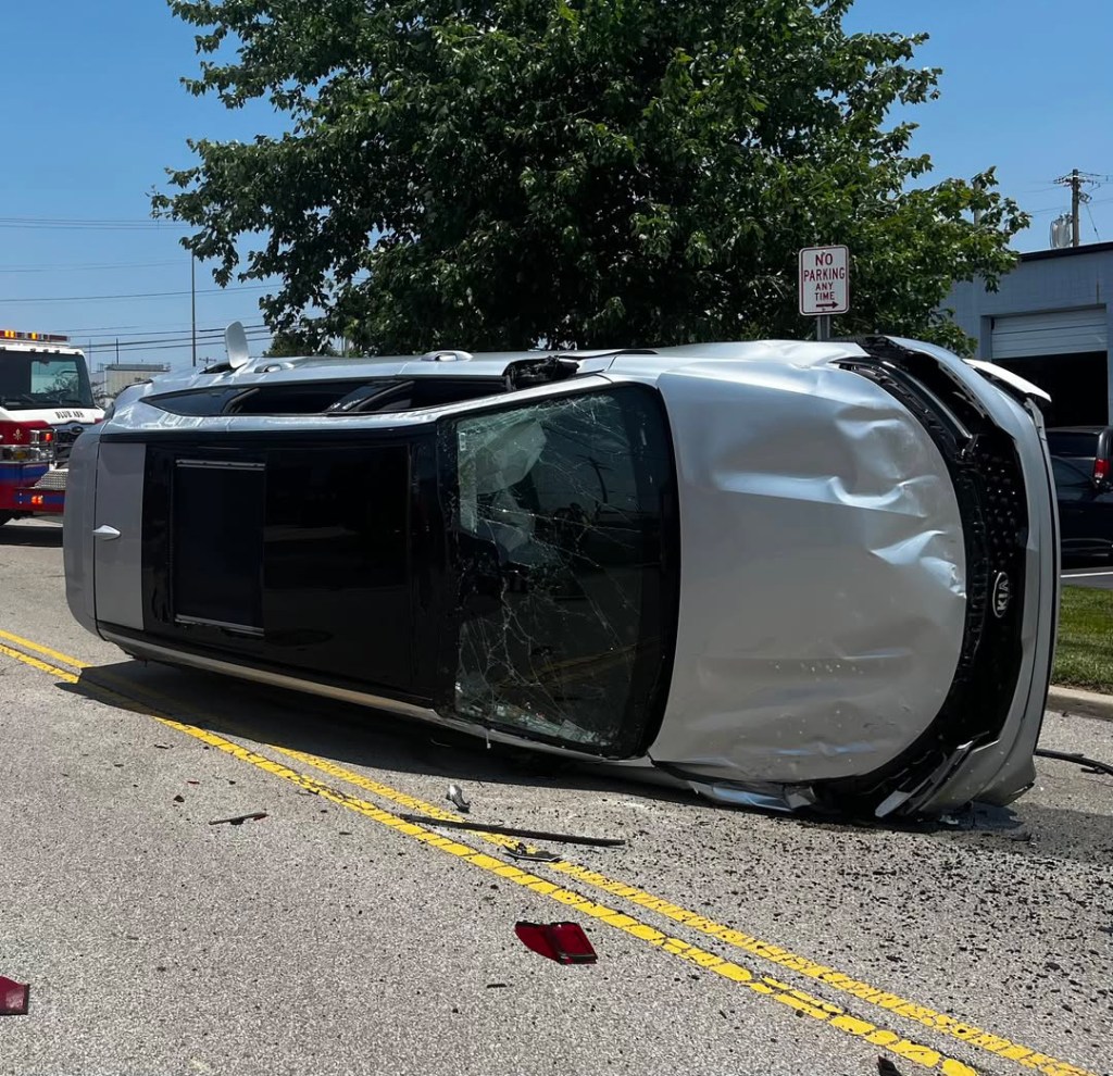 Silver SUV on its side after a cicada-related accident.