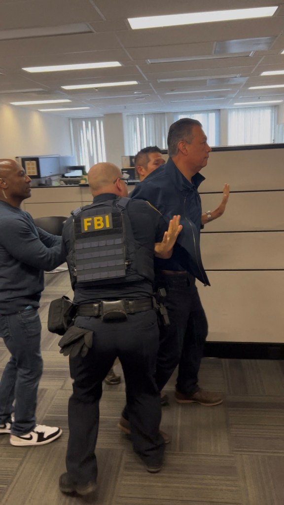Senator Alex Padilla being handcuffed by security.