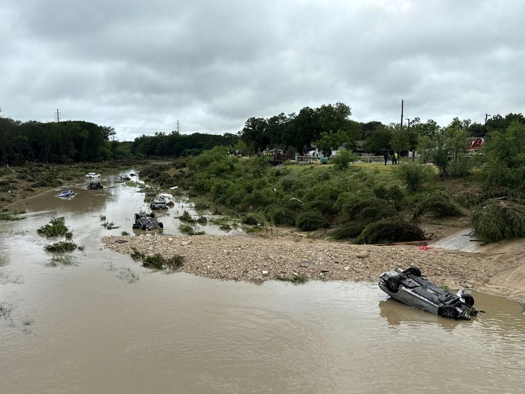 Floodwaters with several submerged cars.