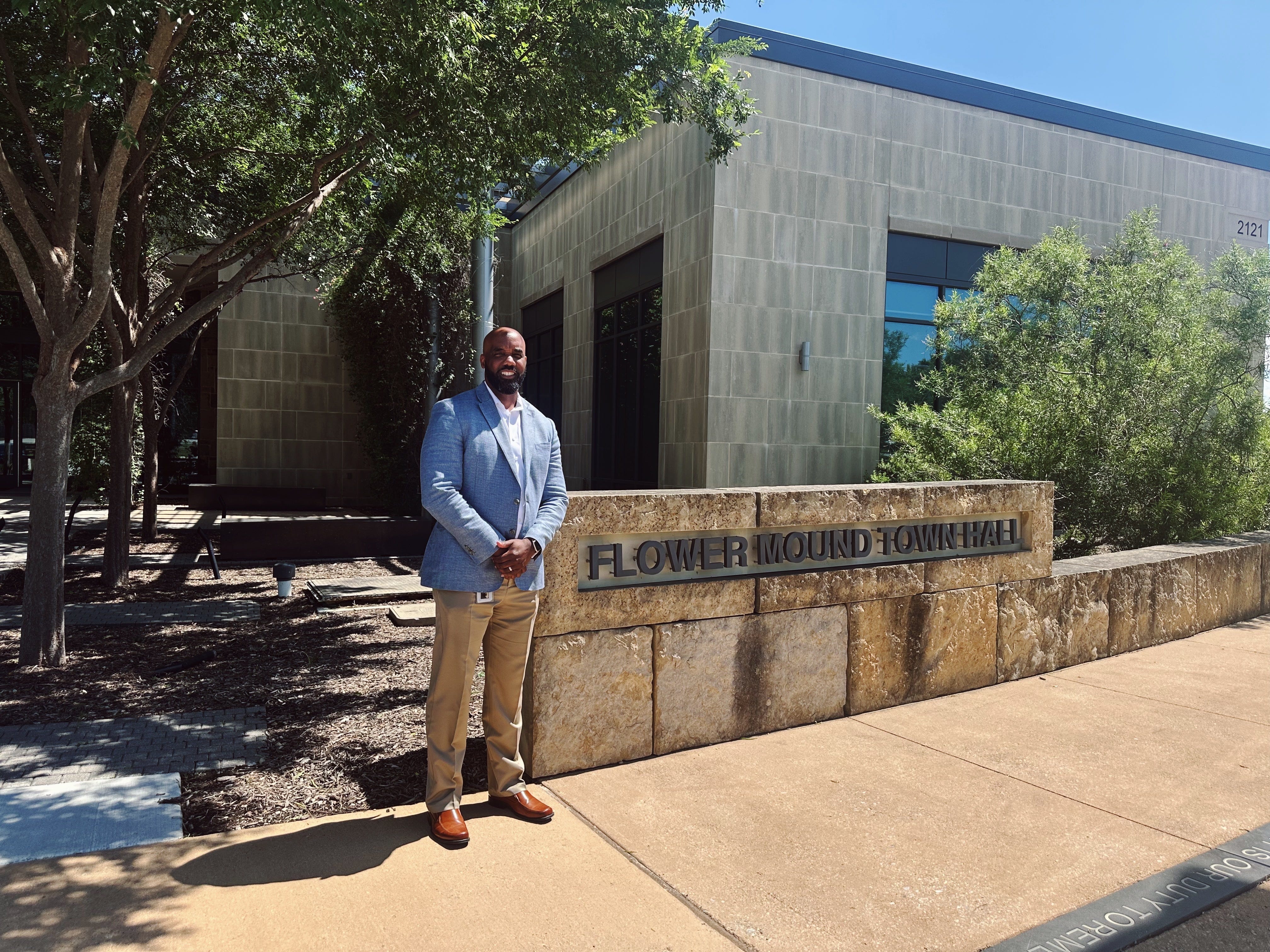 James  Childers is standing in front of the Flower Mound town hall.