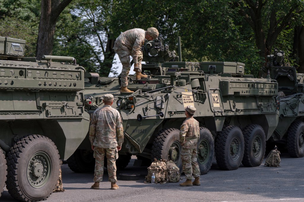 Soldiers preparing Stryker combat vehicles for a military parade.