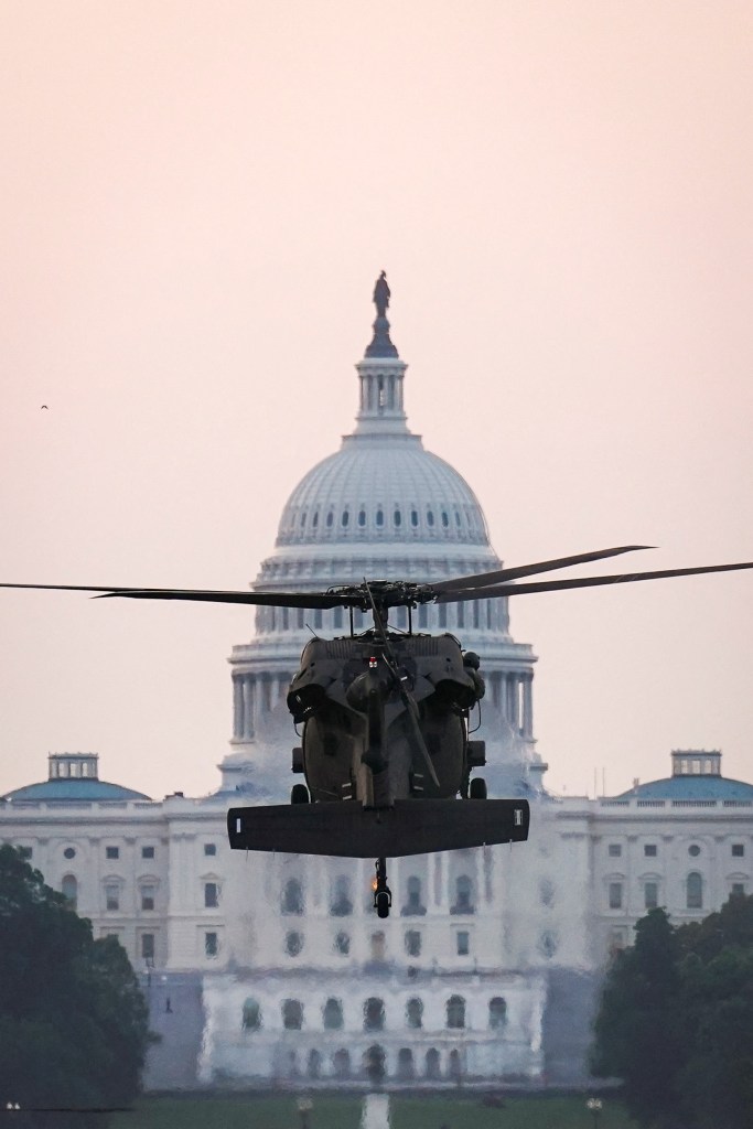 Black Hawk helicopter landing on the National Mall with the U.S. Capitol in the background.