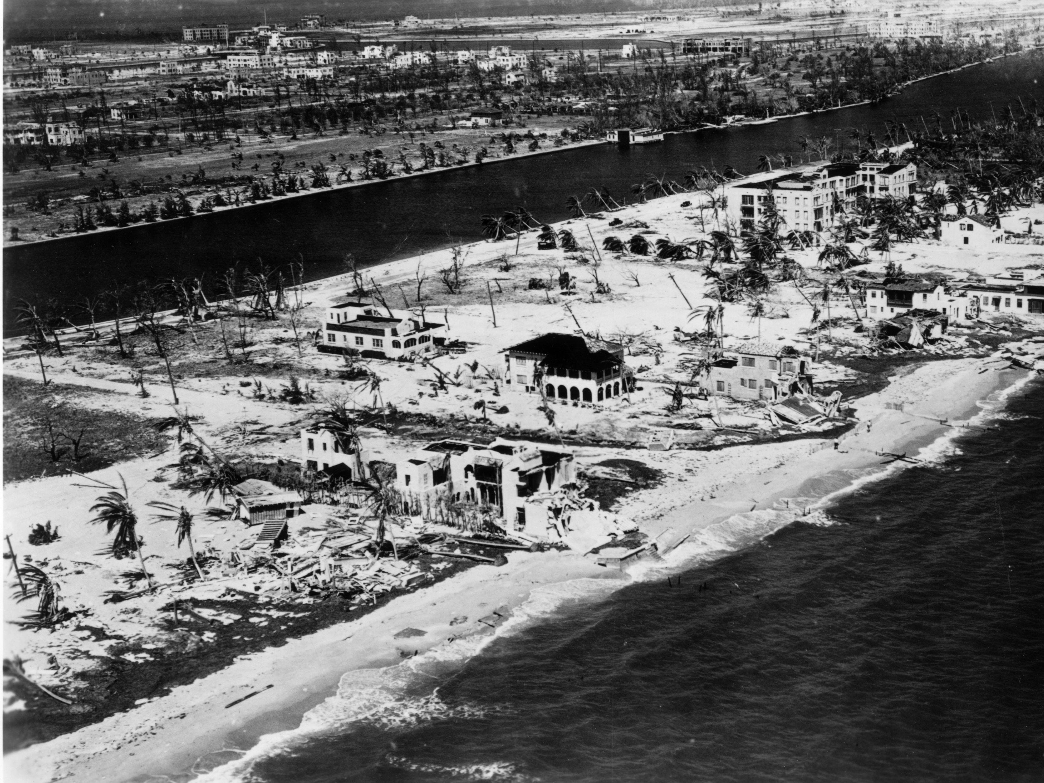A black and white photo showing the aftermath of the Great Miami Hurricane on a beach.
