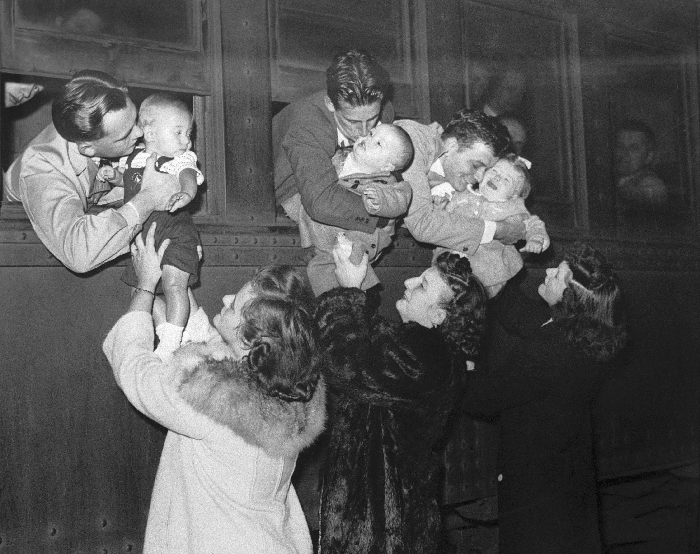 men leaving for war kissing their babies