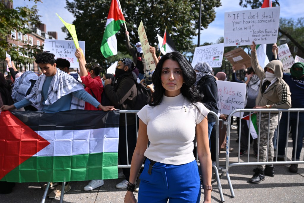 inna vernikov standing outside in front of a protest