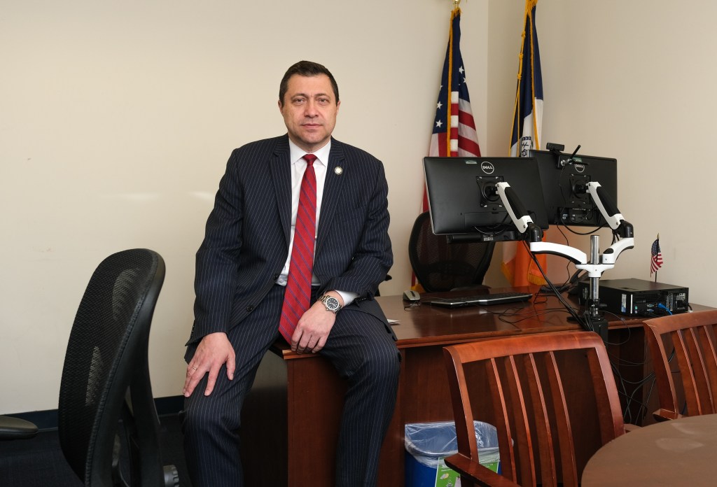 ari kagan in a dark suit and red tie