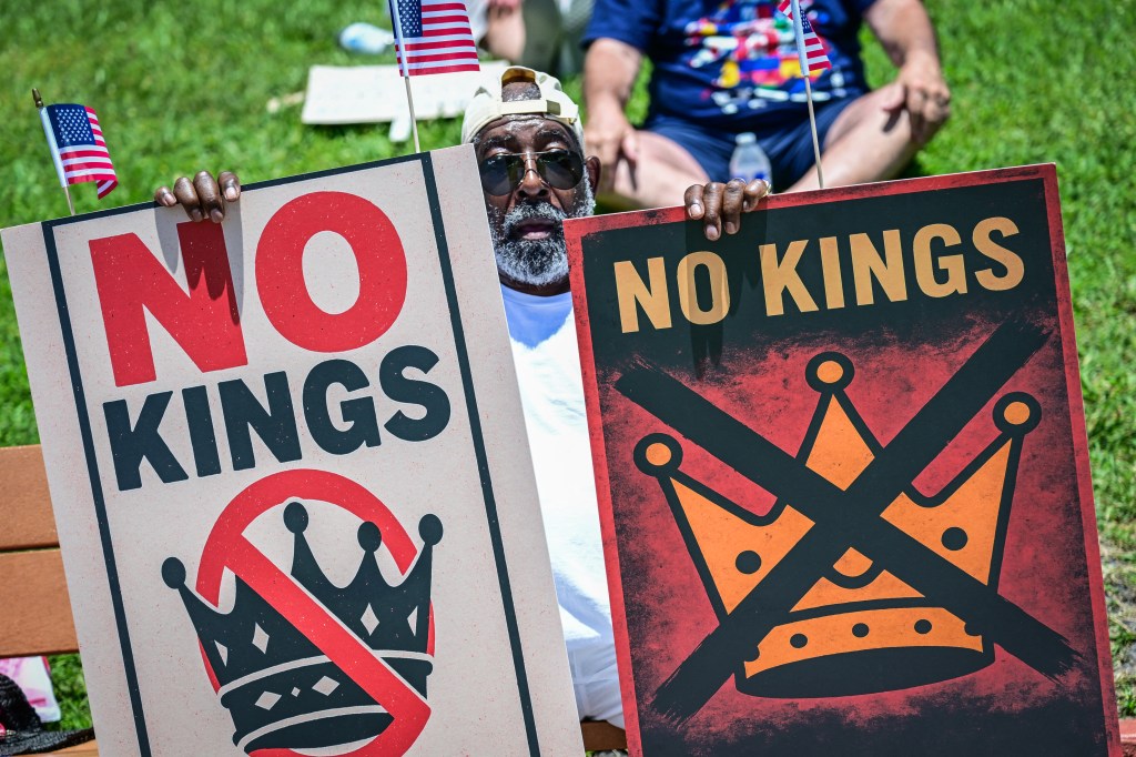 Protestor holding signs that say 