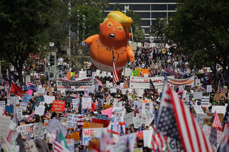 A "Baby Trump" balloon floats over demonstrators taking part in the No Kings protest in Los Angeles, California.