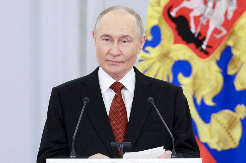 Vladimir Putin speaking at a ceremony.