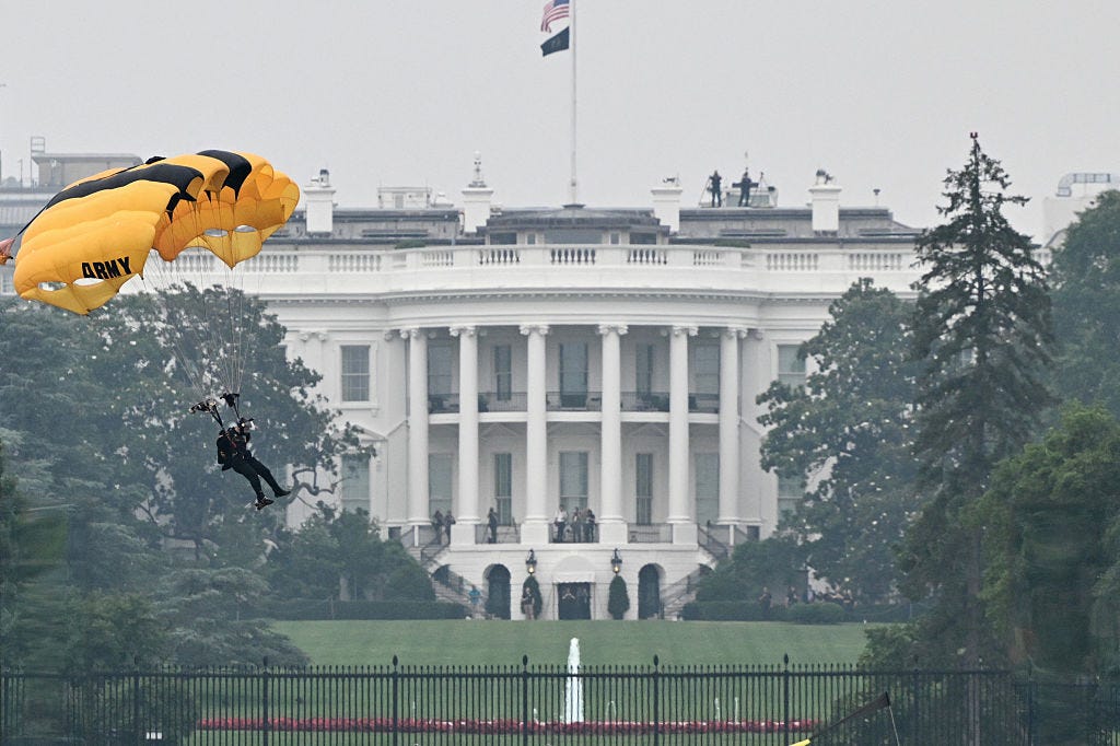 A member of the Golden Knights, the US Army's parachute demonstration and competition team, landed in front of the White House