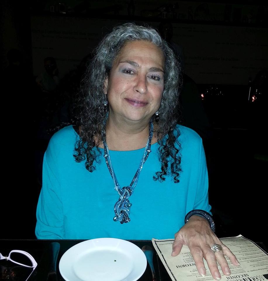 Stacy Rauch, a lifelong Murray Hill resident sitting at a table with a menu in front of her