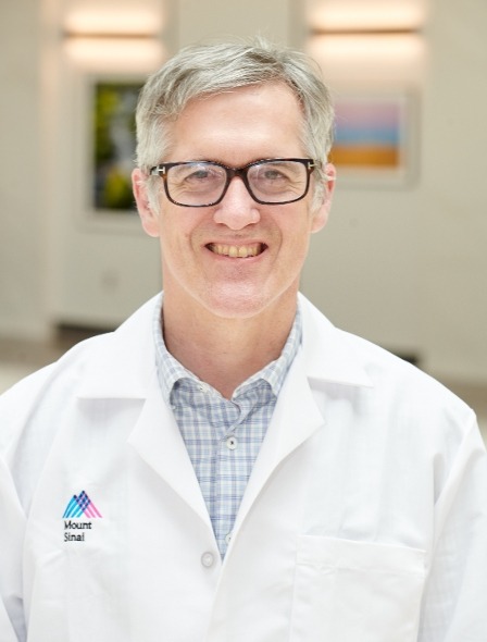 Photo of Barak Friedman in a lab coat.