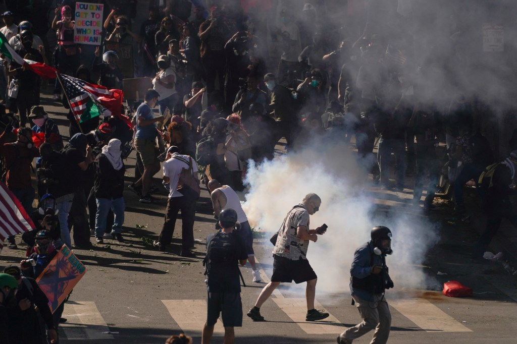 Protestors fleeing tear gas during a Los Angeles demonstration.