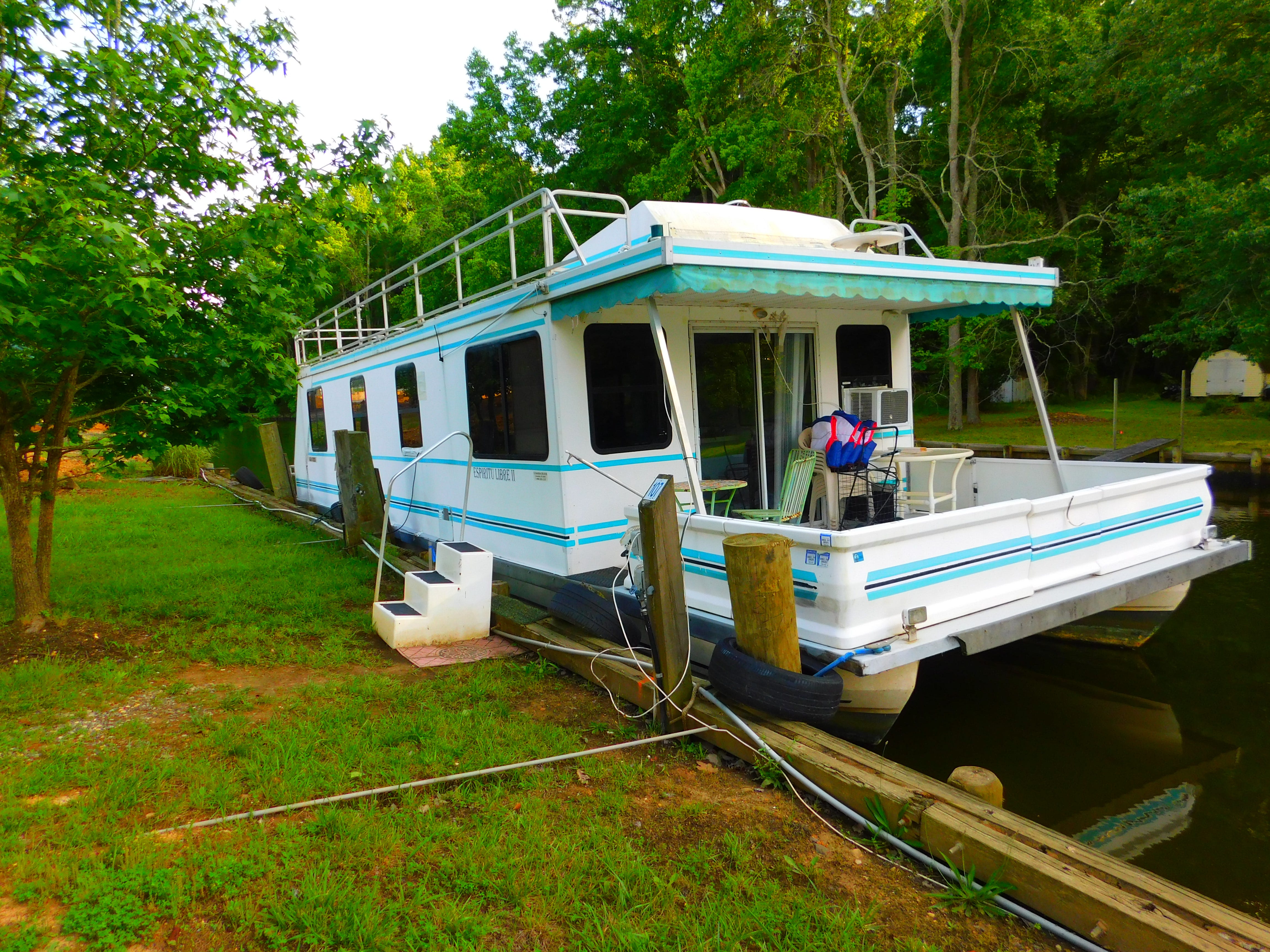 teal blue and white houseboat