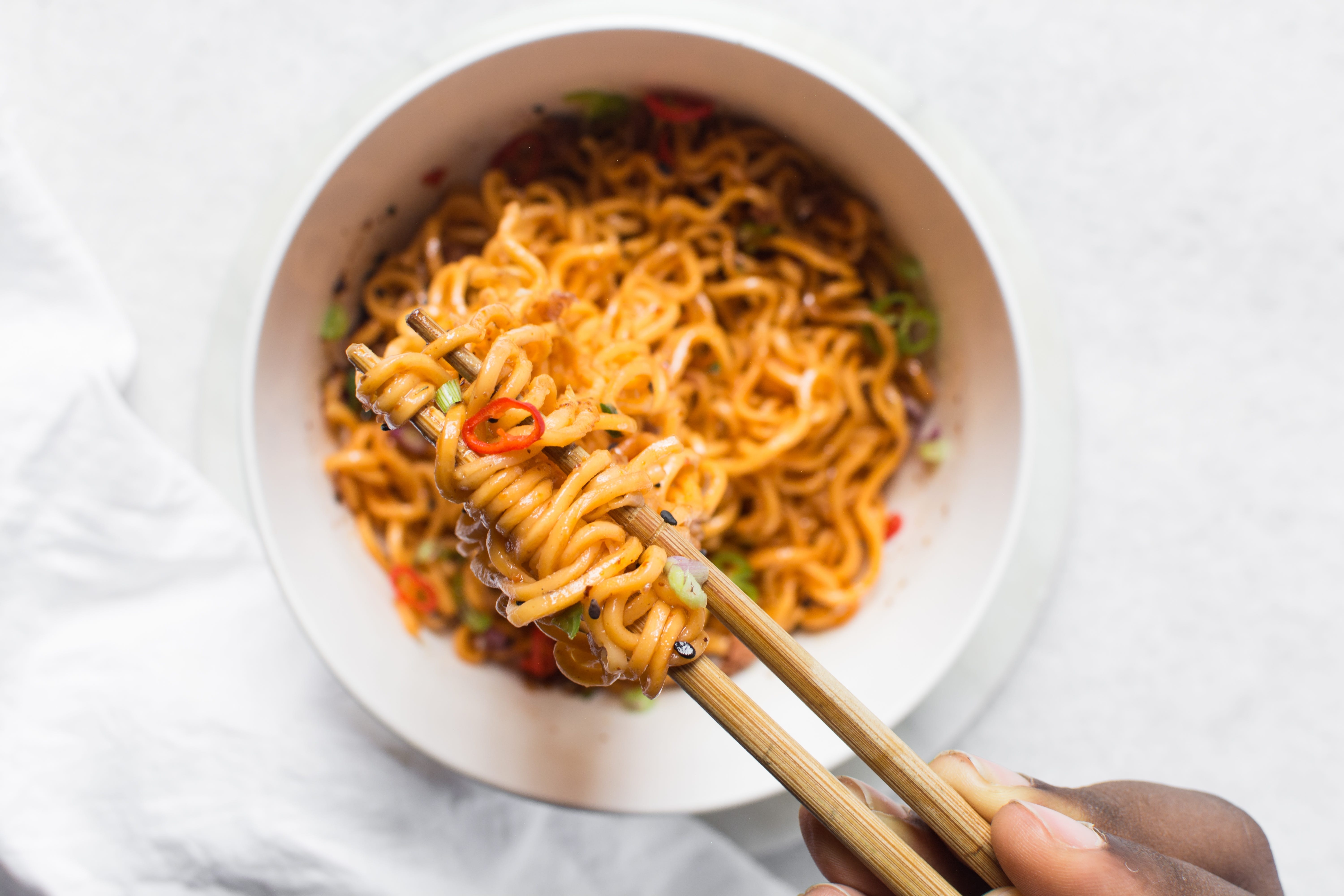 Cheesy noodles being pulled with chopsticks