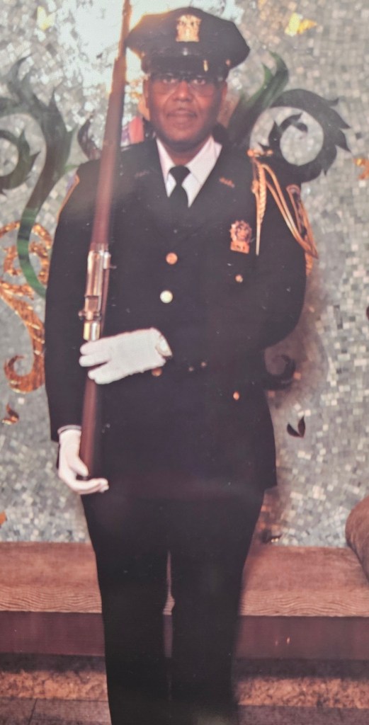 Photo of Shawn Hobson, a retired court officer, holding a rifle.