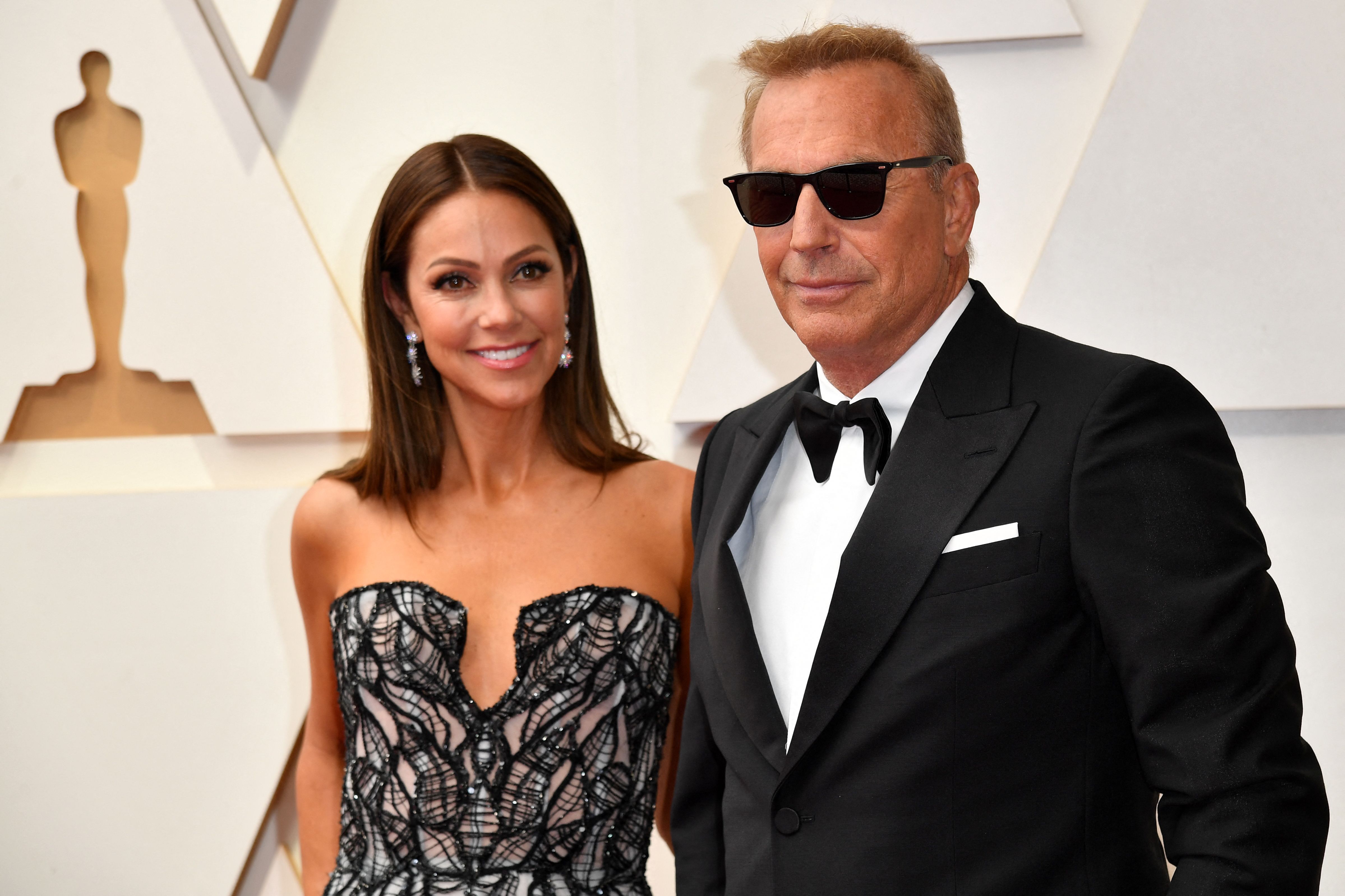 Kevin Costner and Christine Baumgartner at the 2022 Oscars