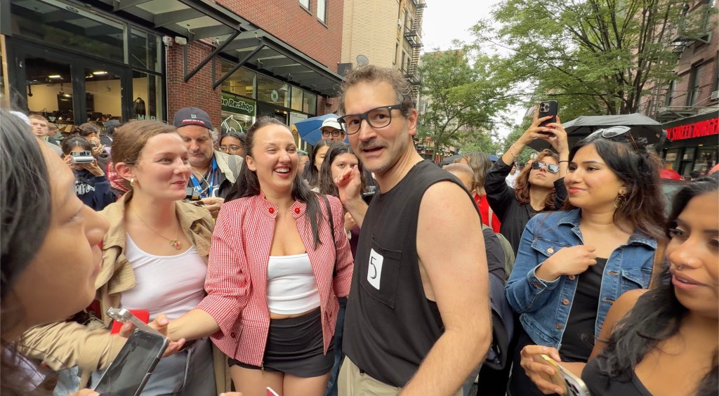 George Gountas, winner of a Pedro Pascal lookalike contest, surrounded by people.