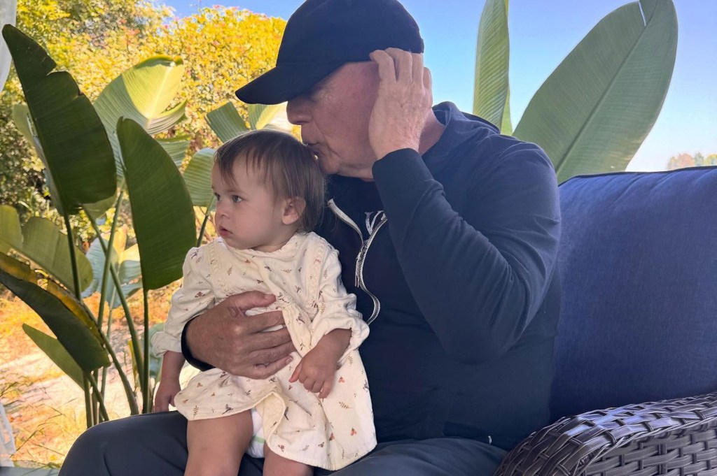 Bruce Willis posing with his granddaughter