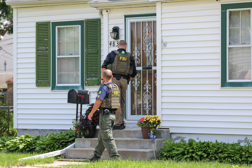 FBI and BCA agents searching a neighboring house to the one Boelter had been living in on June 15, 2025.