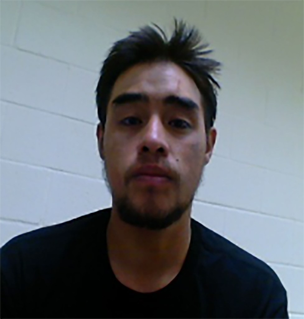 Mugshot of a man with short dark hair.