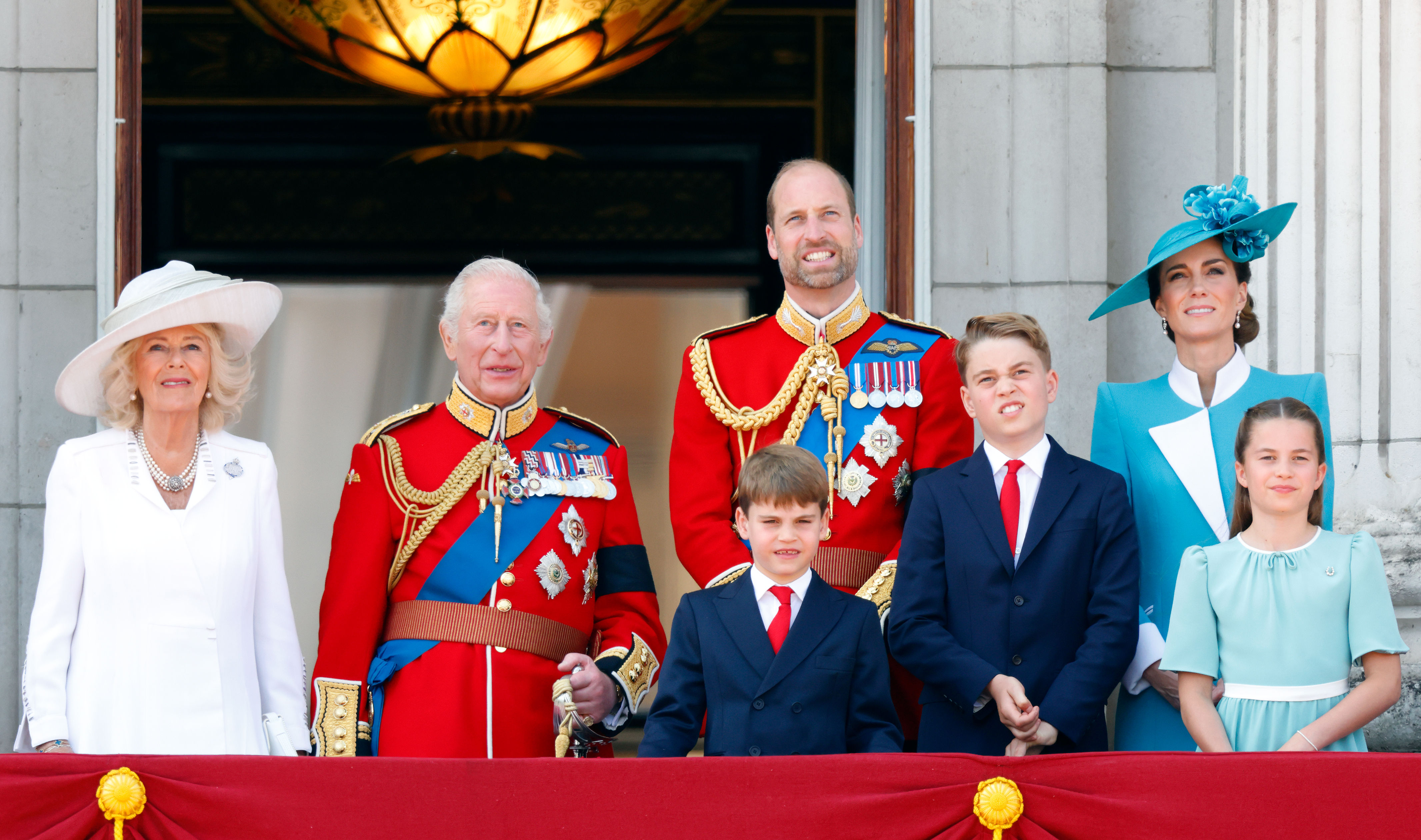 Queen Camilla, King Charles III, Prince Louis, Prince William, Prince George, Kate Middleton and Princess Charlotte watch an RAF flypast from the balcony of Buckingham Palace in 2025