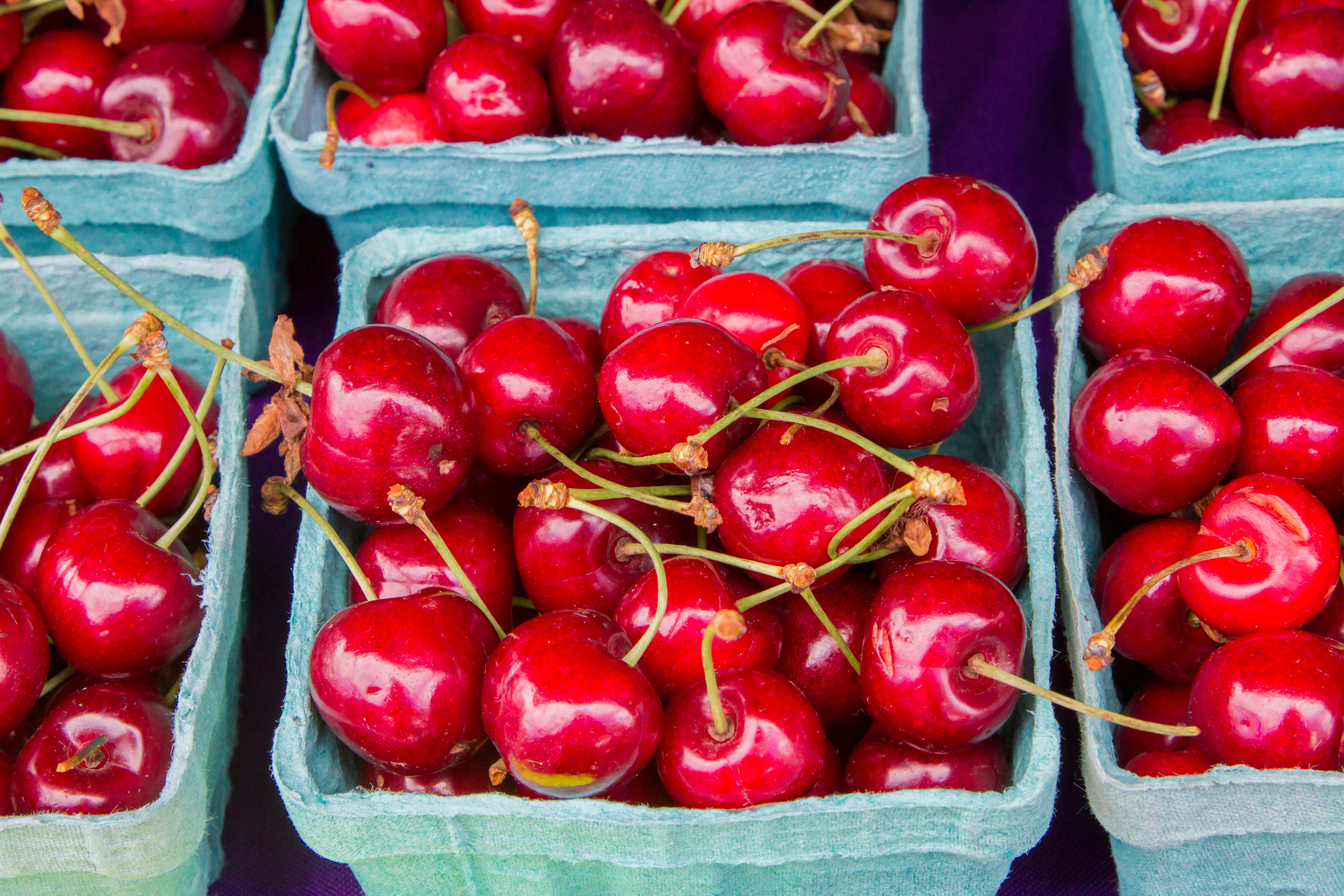 red cherries in blue cartons