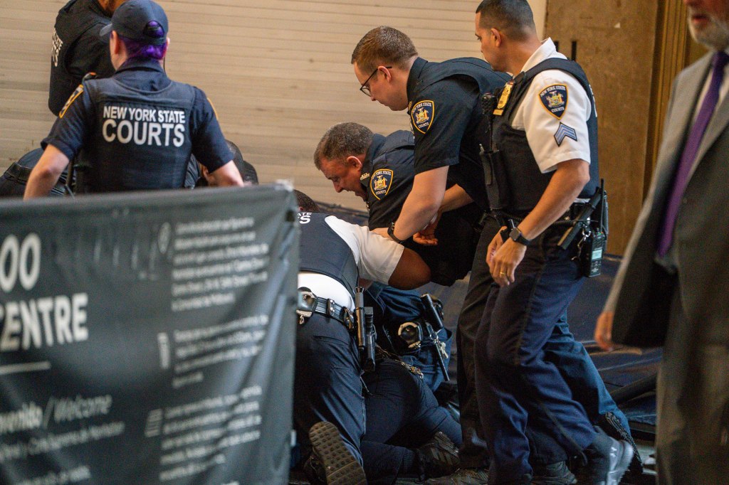 Police officers apprehending a suspect.