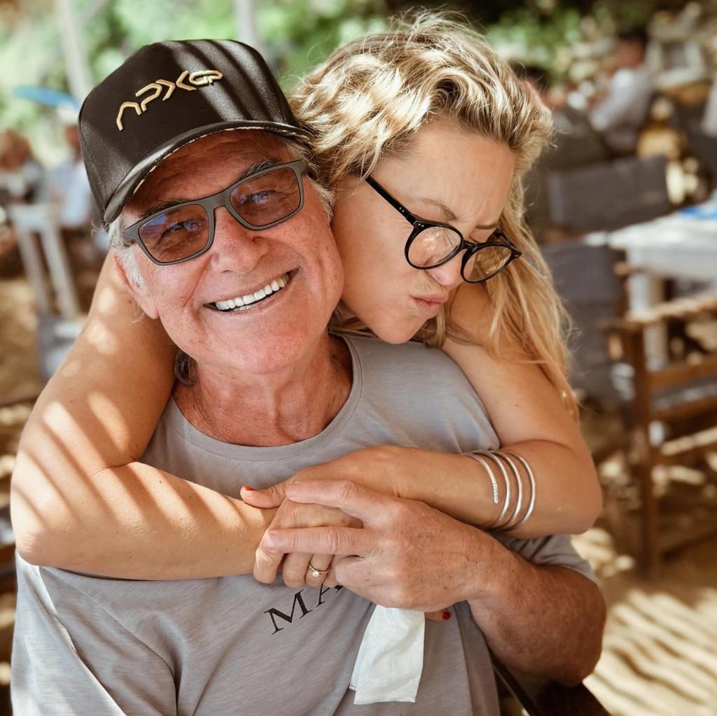 Kate Hudson cuddles up with her dad Kurt Russell.