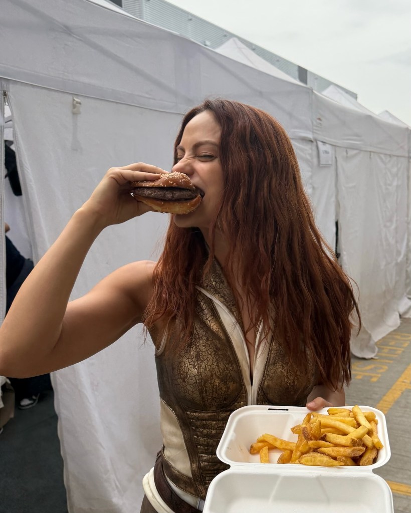 Camille Mendes chows down on a burger and fries.
