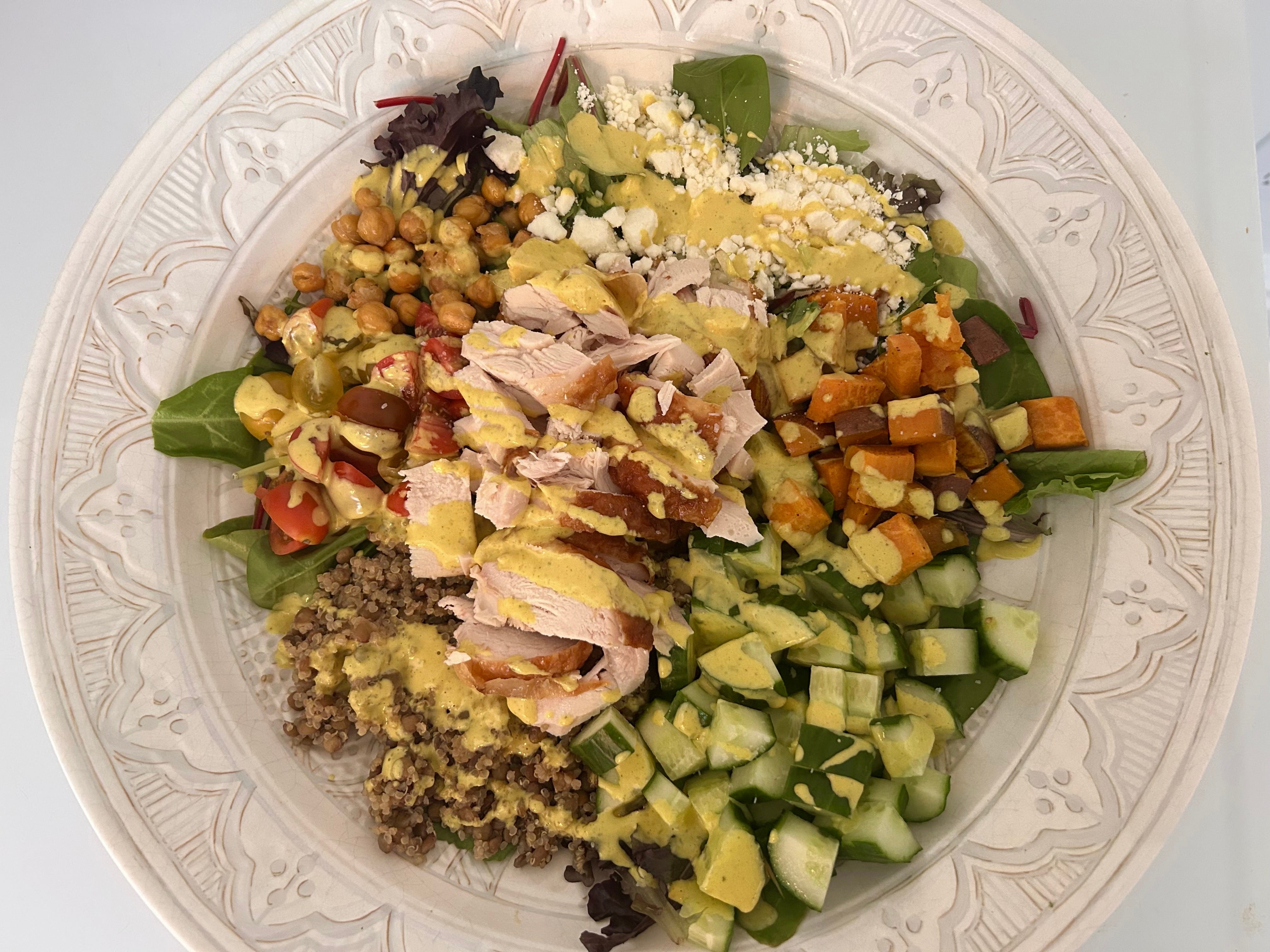 A bowl of quinoa and sweet potato salad with Costco rotisserie chicken.