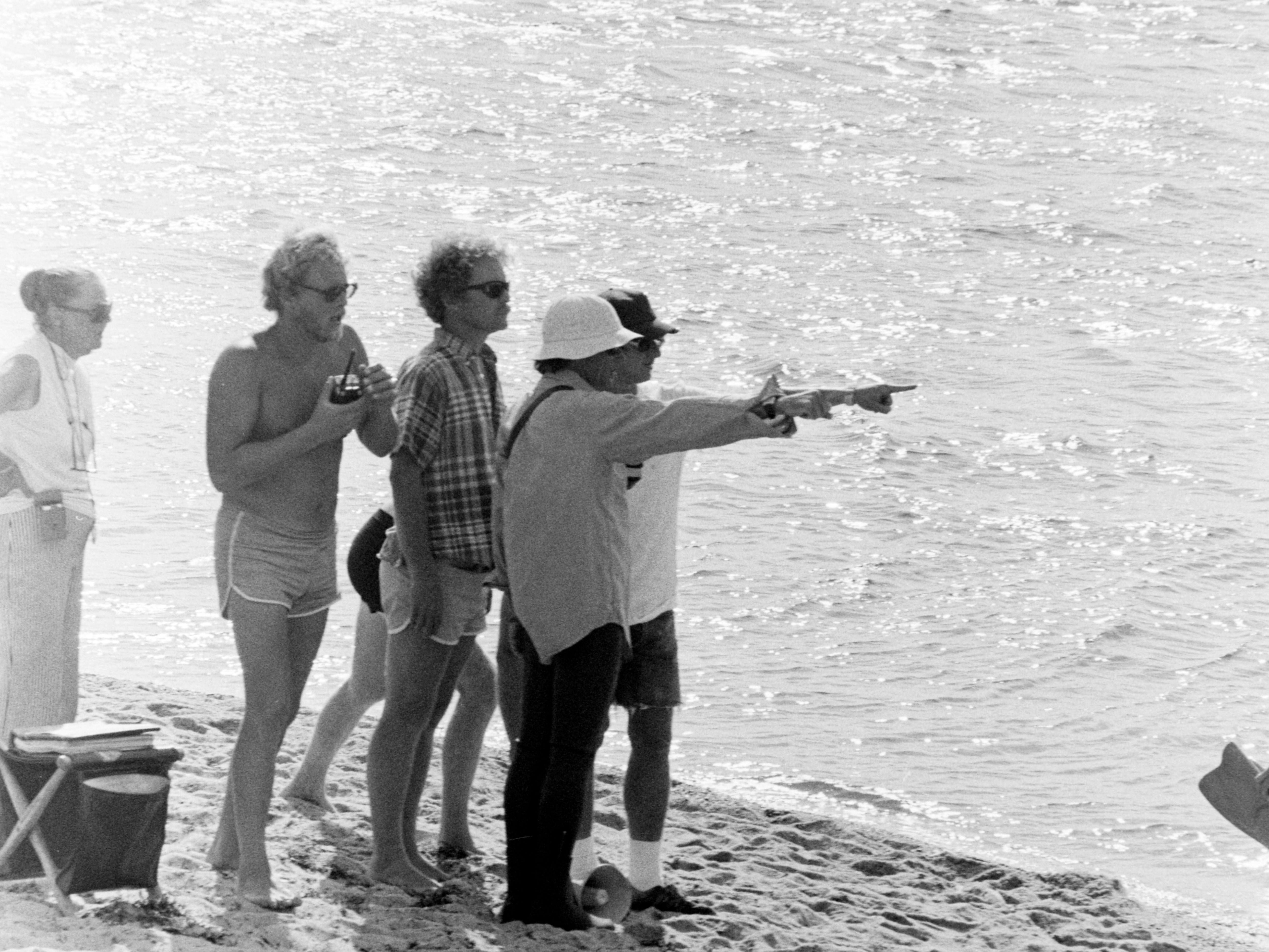 Camera operator Michael Chapman (3rd from L), Cinematographer Bill Butler (wearing white hat), and director Steven Spielberg (R) prepare for filming during production of 