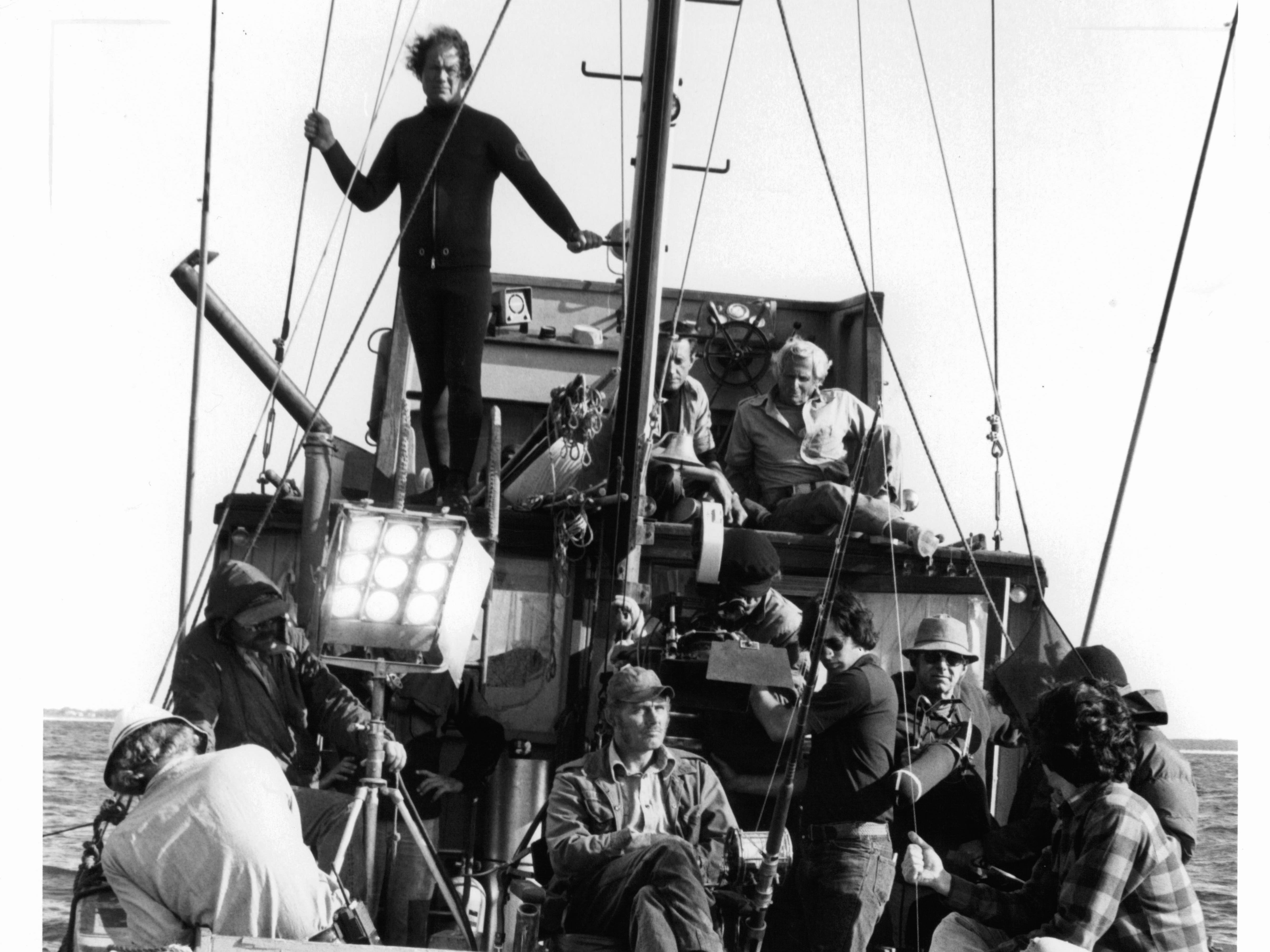 Roy Scheider on top deck as crew set up to film a scene from the film 'Jaws', 1975