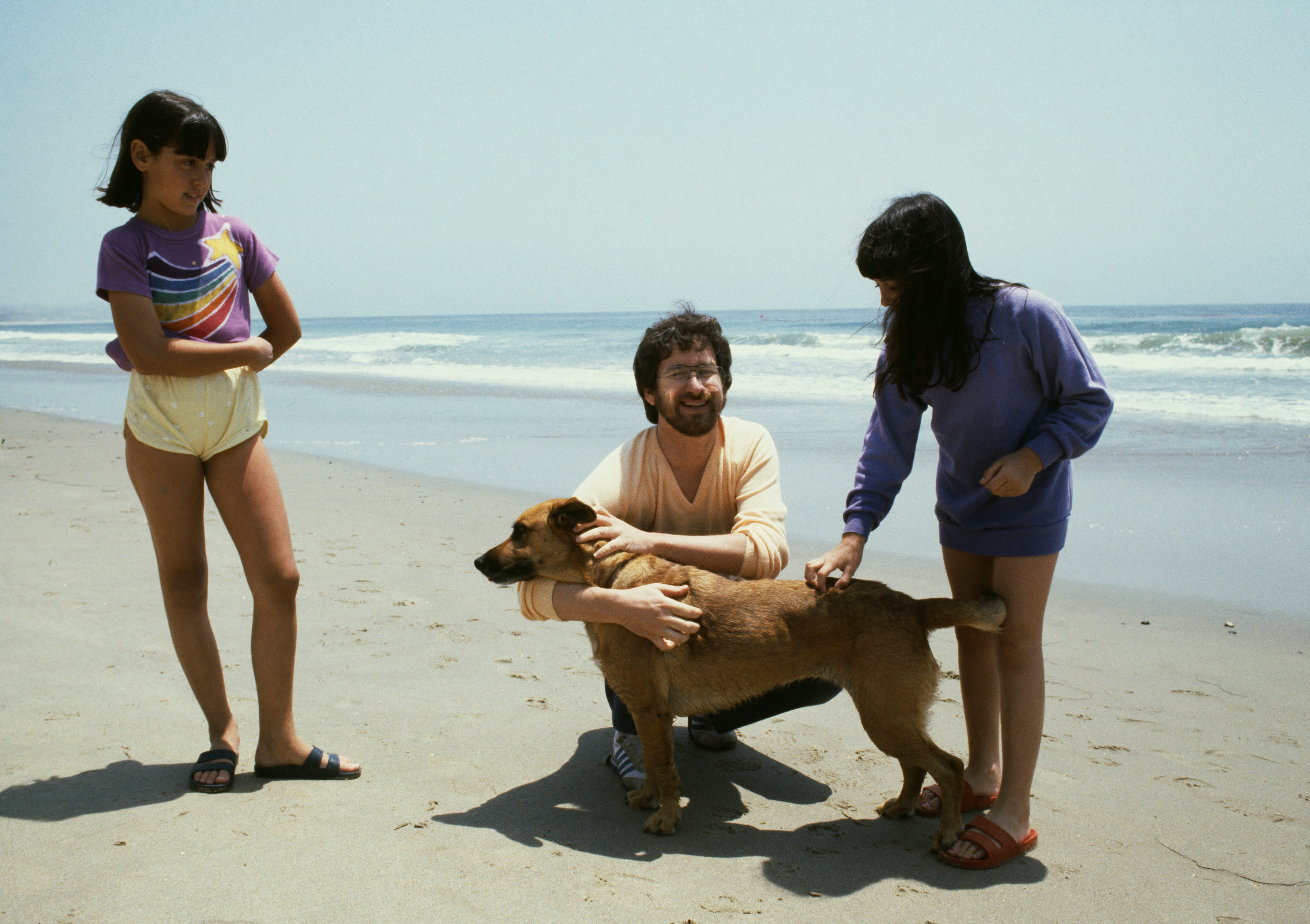 American director, screenwriter and producer Steven Spielberg with his dog on the beach in Los Angeles.
