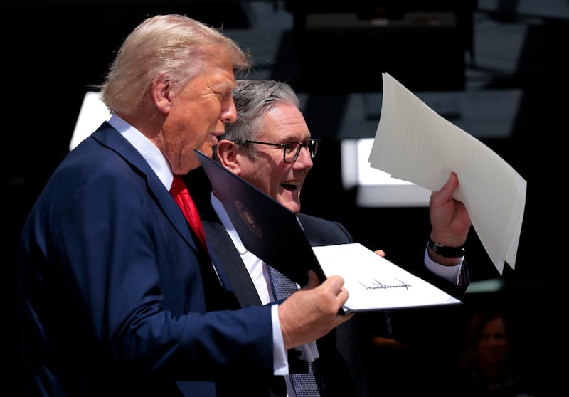 President Donald Trump and British Prime Minister Keir Starmer hold up a signed trade deal as they speak to the press following a bilateral meeting during the G7 Leaders' Summit on June 16, 2025 in Kananaskis, Alberta.